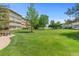 Expansive green lawn with mature trees, offering a serene and picturesque outdoor space at 9320 E Center Ave # 4B, Denver, CO 80247