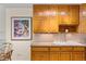 Charming kitchen featuring granite counters, wood cabinetry, and a ceramic sink at 9320 E Center Ave # 4B, Denver, CO 80247