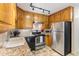 Well-lit kitchen featuring stainless steel appliances, granite countertops, and ample cabinet space at 9320 E Center Ave # 4B, Denver, CO 80247
