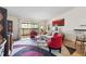 Bright living room with hardwood floors, balcony access, and stylish decor at 9320 E Center Ave # 4B, Denver, CO 80247