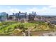 Breathtaking aerial view showcases lush parklands, the river, and a vibrant city skyline beyond the river at 1521 Central St # 2D, Denver, CO 80211