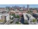 Cityscape aerial view of neighborhood with trees and parked cars in front of a backdrop of modern office towers at 1521 Central St # 2D, Denver, CO 80211
