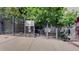 Gated entrance to The Overlook condos at 2525 and 2501 with mature trees and landscaping at 1521 Central St # 2D, Denver, CO 80211