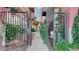 Gated walkway leading to modern condos surrounded by lush landscaping and secure access at 1521 Central St # 2D, Denver, CO 80211