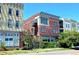 Attractive three-story brick building with modern architectural details and lush greenery at 1521 Central St # 2D, Denver, CO 80211