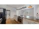 Efficient kitchen featuring stainless steel appliances, an eat-in island, and plenty of natural light at 1521 Central St # 2D, Denver, CO 80211