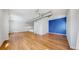 Large living room area with open concept, wood floors, white walls and ductwork at 1521 Central St # 2D, Denver, CO 80211
