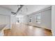Open concept living space with modern finishes, hardwood floors, and large windows for natural light at 1521 Central St # 2D, Denver, CO 80211