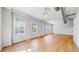 Bright living area with many windows, wood floors, and neutral walls at 1521 Central St # 2D, Denver, CO 80211