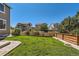 Green backyard with a wooden fence and stone pavers at 10201 Rifle St, Commerce City, CO 80022