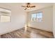Cozy bedroom featuring natural lighting, a ceiling fan, and wood floors at 10201 Rifle St, Commerce City, CO 80022