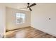 Bedroom featuring natural lighting, a ceiling fan, and wood floors at 10201 Rifle St, Commerce City, CO 80022