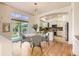 Open dining area features hardwood floors, contemporary light fixture, slider doors to the backyard, and a kitchen bar at 10201 Rifle St, Commerce City, CO 80022