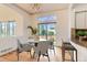 Bright dining area with modern lighting, a marble table, slider door, and backyard views at 10201 Rifle St, Commerce City, CO 80022