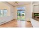 Dining room with hardwood floors, stained-glass window, and sliding glass doors to the back yard at 10201 Rifle St, Commerce City, CO 80022