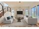 Stylishly furnished living room with hardwood floors, a stone accent wall, and modern decor at 10201 Rifle St, Commerce City, CO 80022