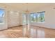 Spacious living room featuring hardwood floors, modern lighting, and a stone accent wall at 10201 Rifle St, Commerce City, CO 80022
