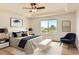 Stylized main bedroom featuring tray ceiling, large window with natural light, and modern decor at 10201 Rifle St, Commerce City, CO 80022