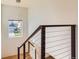 Modern staircase with metal railing and stylish pendant lighting at 10201 Rifle St, Commerce City, CO 80022