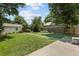 Large, well-maintained backyard offers a green lawn, wood fence, storage shed, and concrete walkway at 1712 S Gilpin St, Denver, CO 80210