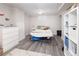 Finished basement bedroom with a bed and updated flooring at 1712 S Gilpin St, Denver, CO 80210