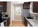 Efficient kitchen featuring dark wood cabinets, granite countertops, and stainless steel appliances at 1712 S Gilpin St, Denver, CO 80210