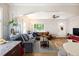 Spacious living room with hardwood floors, comfortable sofas, and an archway to the dining area at 1712 S Gilpin St, Denver, CO 80210