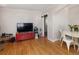 Cozy living room featuring hardwood floors and a red entertainment center at 1712 S Gilpin St, Denver, CO 80210