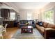 Cozy living room featuring hardwood floors, comfortable seating, and a seamless flow to the kitchen at 1712 S Gilpin St, Denver, CO 80210