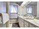 Bathroom features a large mirror and white marble countertop at 3820 S Ames St, Denver, CO 80235