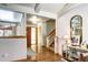 Open-concept foyer leads to stairs and living area with hardwood floors at 3820 S Ames St, Denver, CO 80235