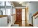 Inviting foyer with wood flooring, closet, and decorative glass door panel at 3820 S Ames St, Denver, CO 80235
