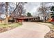 Spacious brick home with an attached garage and beautiful landscaping at 3820 S Ames St, Denver, CO 80235