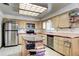 Kitchen with stainless steel appliances, plenty of cabinet space, and a bright skylight at 3820 S Ames St, Denver, CO 80235