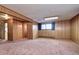 Large living space with paneled walls and plush carpet offers versatile layout options with lots of light at 3820 S Ames St, Denver, CO 80235