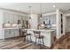 Kitchen featuring stainless appliances, gray cabinets, kitchen island with bar seating, and modern lighting at 15376 Ivanhoe Ct, Thornton, CO 80602