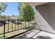 Comfortable balcony offers a view of the parking area and large shade trees, with black metal railing at 2375 S Linden Ct # 201, Denver, CO 80222