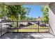 Cozy balcony with black metal railing offers a view of the parking area and large shade trees at 2375 S Linden Ct # 201, Denver, CO 80222