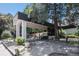 Welcoming entrance to the building with a covered drive-through and meticulously landscaped grounds at 2375 S Linden Ct # 201, Denver, CO 80222