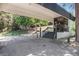 Building entrance features covered drive through with steps up to entrance and mature landscaping at 2375 S Linden Ct # 201, Denver, CO 80222