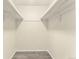 Walk-in closet with shelves and hardwood flooring at 2375 S Linden Ct # 201, Denver, CO 80222