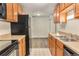 Kitchen features wooden cabinets, black appliances, and tile flooring at 2375 S Linden Ct # 201, Denver, CO 80222