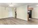 Open living room with wood flooring flowing into the kitchen, creating a seamless space at 2375 S Linden Ct # 201, Denver, CO 80222