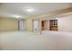 Spacious basement with neutral carpet, paneled walls, recessed lighting, and a storage space at 16246 E Hamilton Pl, Aurora, CO 80013