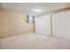 Basement bedroom with carpeting, light walls, a window, and large closet doors for storage at 16246 E Hamilton Pl, Aurora, CO 80013