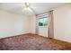 Bedroom features carpet flooring, a window with natural light, and neutral walls at 16246 E Hamilton Pl, Aurora, CO 80013