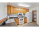 Functional kitchen features light wood cabinets, white appliances, and a walk-in pantry at 16246 E Hamilton Pl, Aurora, CO 80013