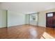 Bright living room showcases hardwood floors, large window, and a neutral color palette at 16246 E Hamilton Pl, Aurora, CO 80013