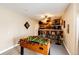 Finished basement featuring a custom wet bar area with a foosball table for fun and entertainment at 34942 Wagon Wheel Trl, Elizabeth, CO 80107