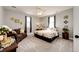 Bedroom featuring a ceiling fan, large bed, and comfortable sofa with a modern aesthetic at 34942 Wagon Wheel Trl, Elizabeth, CO 80107
